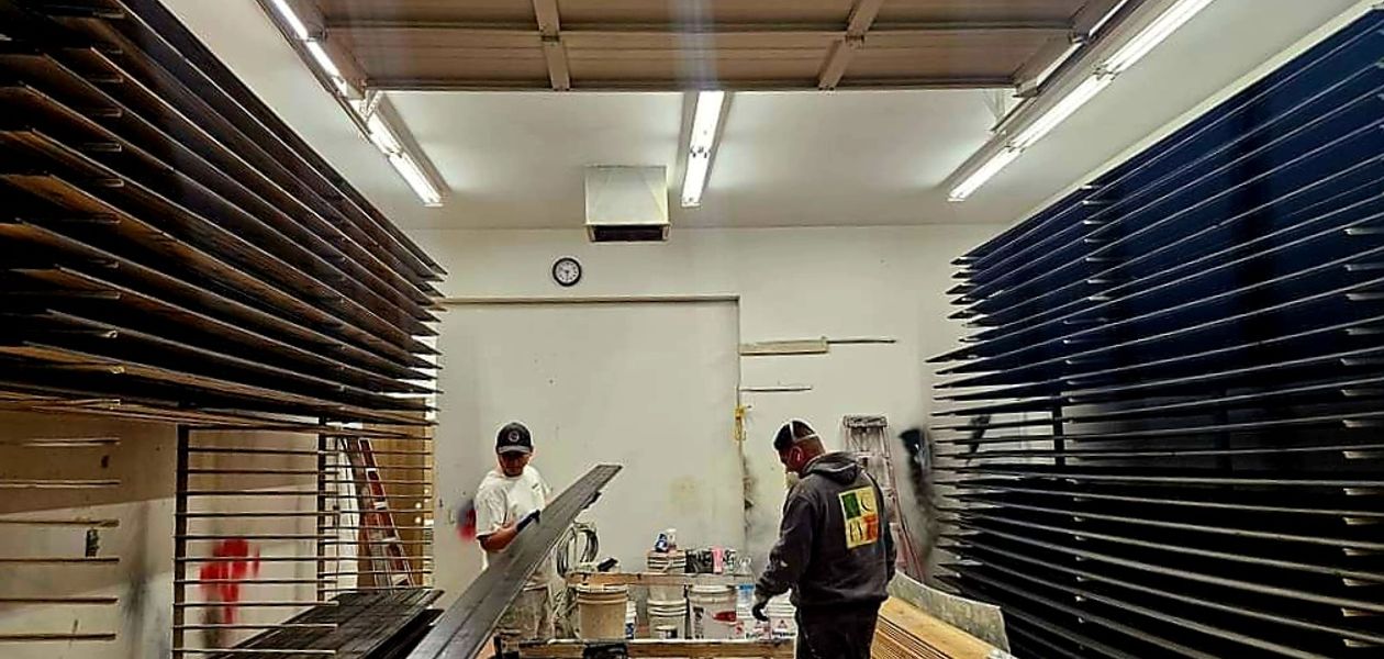 crew inside the shop working on cabinet painting